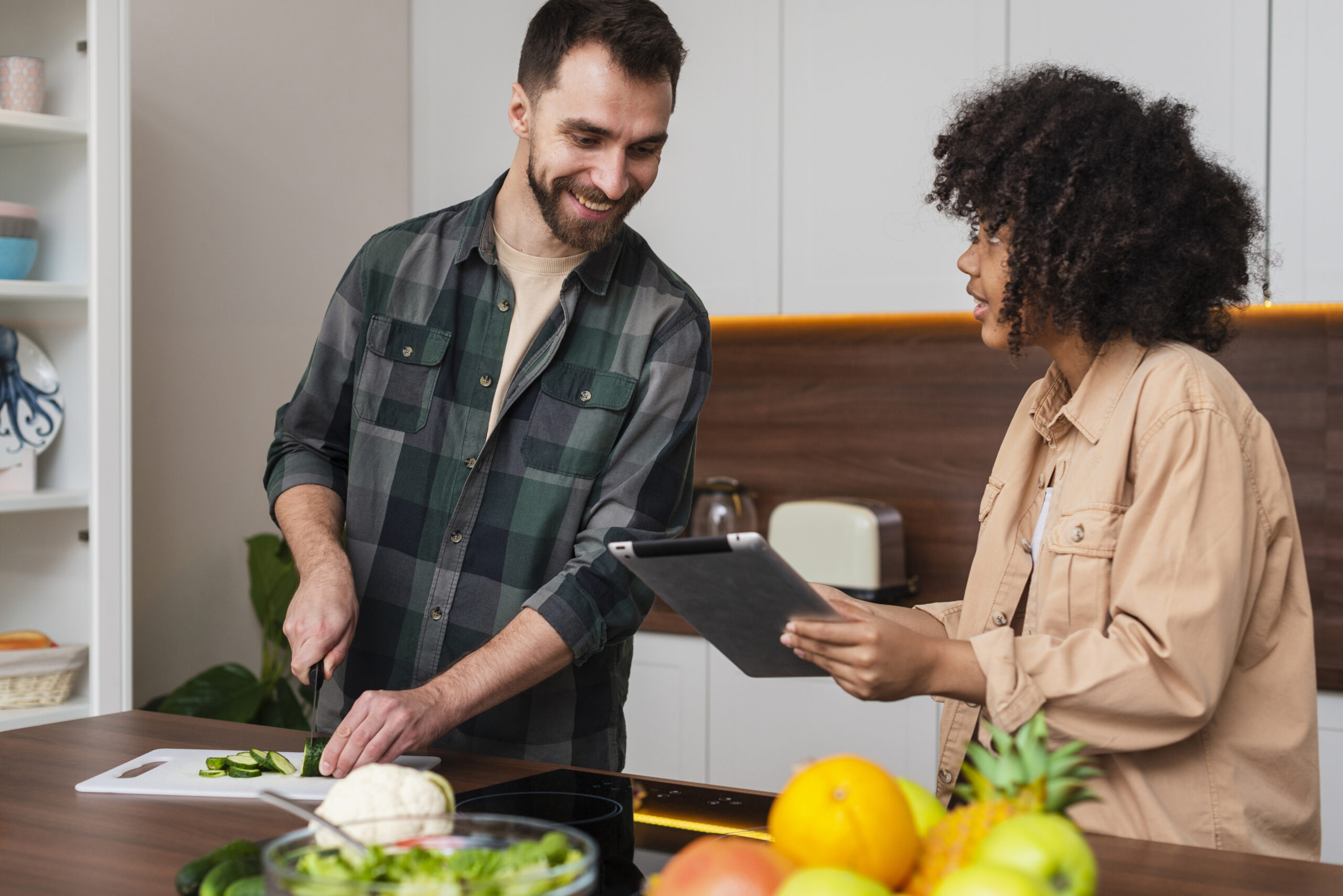 woman showing something tablet man cooking